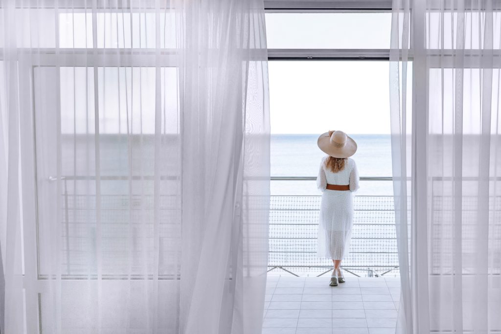 A writer enjoys the view of the sea with a beautiful view from the terrace in the early summer morning.